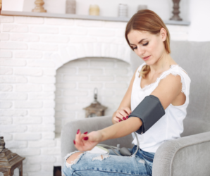 woman checking blood pressure at home