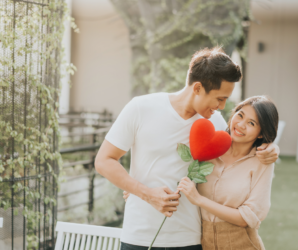 partner showing romantic gesture with a heart-shaped plush gift